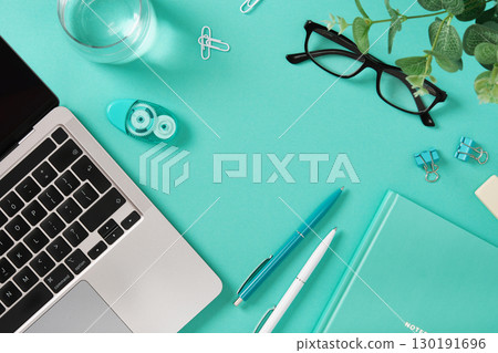 Stationery background with laptop, notebook, pens. Workspace for learning, creativity, and productivity. 130191696