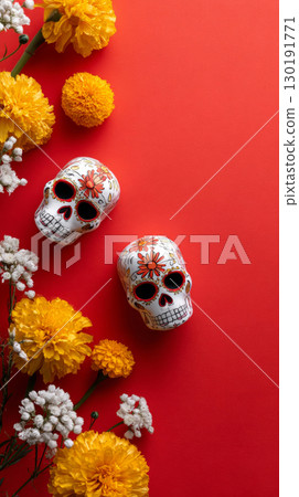 Bold red surface adorned with vibrant calaveras and marigolds for Dia de Muertos celebration in Mexico 130191771