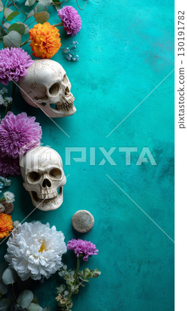 Vibrant turquoise backdrop featuring decorative skulls and colorful flowers for Day of the Dead celebration 130191782