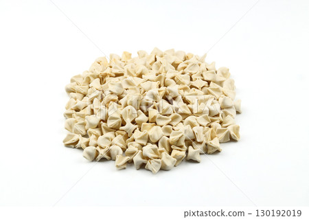 handmade manti (turkish ravioli type dumplings) on white background, before cooking 130192019