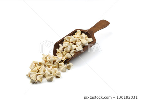 handmade manti (turkish ravioli type dumplings) on wooden scoop,  before cooking. isolated on white background 130192031