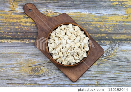 handmade manti (turkish ravioli type dumplings) on wooden   bowl, before cooking 130192044