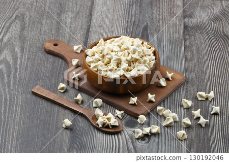 handmade manti (turkish ravioli type dumplings) on wooden   bowl, before cooking 130192046