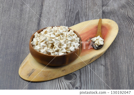 handmade manti (turkish ravioli type dumplings) on wooden bowl, before cooking handmade manti (turkish ravioli type dumplings) on wooden bowl, before cooking 130192047
