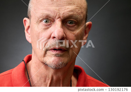 Closeup portrait of a senior man making funny faces Closeup portrait of a senior man making funny faces 130192176