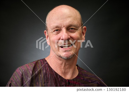Closeup portrait of a senior man making funny faces 130192180