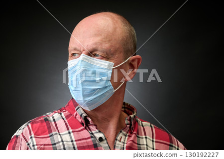 Closeup portrait of a elderly man in studio wearing a facial mask Closeup portrait of a elderly man in studio wearing a facial mask 130192227