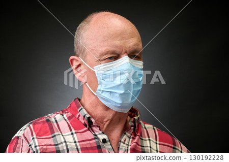 Closeup portrait of a elderly man in studio wearing a facial mask Closeup portrait of a elderly man in studio wearing a facial mask 130192228