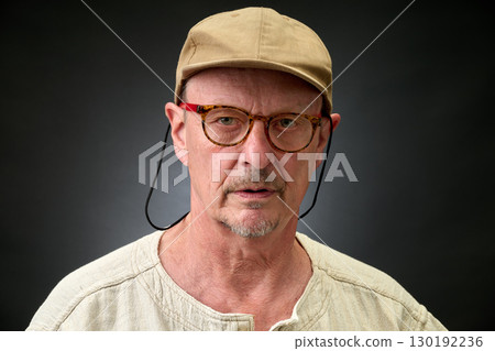 Closeup portrait of senior with a brown Cap Closeup portrait of senior with a brown Cap 130192236