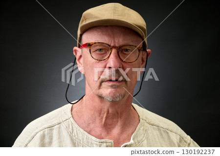 Closeup portrait of  senior with a brown Cap 130192237