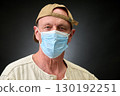 Closeup portrait of a elderly man in studio wearing a facial mask 130192251