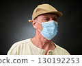 Closeup portrait of a elderly man in studio wearing a facial mask 130192253
