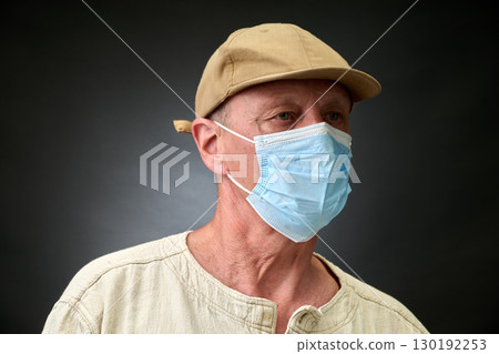 Closeup portrait of a elderly man in studio wearing a facial mask 130192253