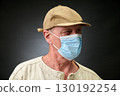 Closeup portrait of a elderly man in studio wearing a facial mask 130192254