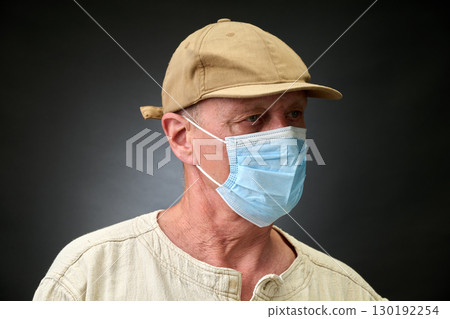 Closeup portrait of a elderly man in studio wearing a facial mask 130192254
