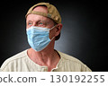 Closeup portrait of a elderly man in studio wearing a facial mask 130192255