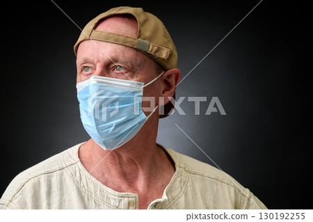 Closeup portrait of a elderly man in studio wearing a facial mask 130192255