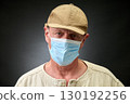 Closeup portrait of a elderly man in studio wearing a facial mask 130192256