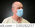 Closeup portrait of a elderly man in studio wearing a facial mask 130192257