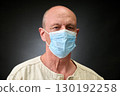 Closeup portrait of a elderly man in studio wearing a facial mask 130192258