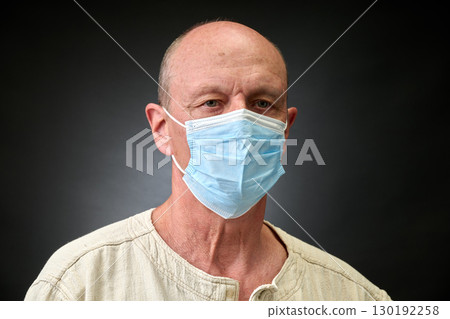 Closeup portrait of a elderly man in studio wearing a facial mask 130192258