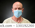 Closeup portrait of a elderly man in studio wearing a facial mask 130192260