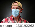 Closeup portrait of a elderly man in studio wearing a facial mask 130192262