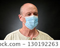 Closeup portrait of a elderly man in studio wearing a facial mask 130192263