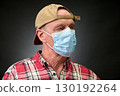 Closeup portrait of a elderly man in studio wearing a facial mask 130192264