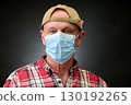 Closeup portrait of a elderly man in studio wearing a facial mask 130192265