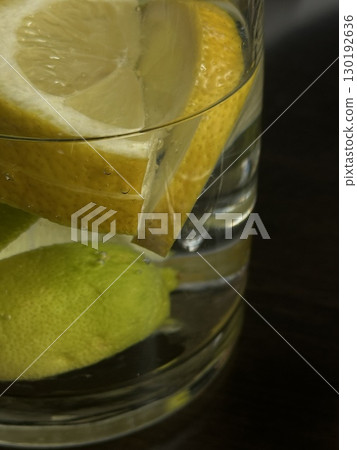 Close up of glass of water with lemon and lime slices. Concept of hydration, healthy drink, wellness, freshness, detox and clean lifestyle. 130192636
