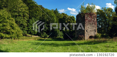 19th-century stone lime kiln in Leszczyniec, Lower Silesia, Poland, stands as an immovable heritage monument with weathered masonry, moss accents, and rustic industrial charm amid verdant surroundings 19th-century stone lime kiln in Leszczyniec, Lower Silesia, Poland, stands as an immovable heritage monument with weathered masonry, moss accents, and rustic industrial charm amid verdant surroundings 130192720