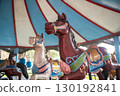 Old Merry-go-round horses in amusement park 130192841