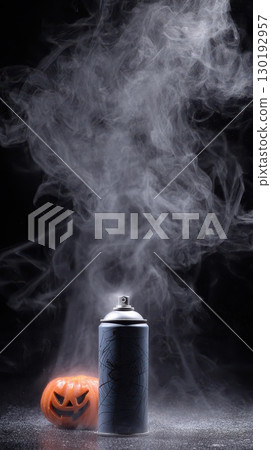 Creative spray can emits smoke above a pumpkin 130192957