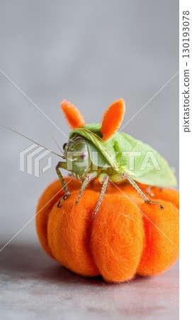 Grasshopper dressed as a bunny on orange pumpkin 130193078