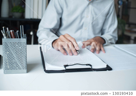 Businessman reading contract in the office. 130193410