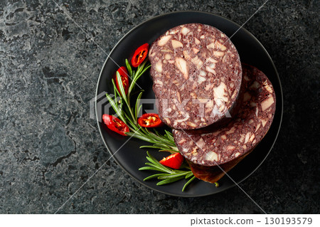 Spanish black pudding or blood sausage accompanied by rosemary and red pepper. Spanish black pudding or blood sausage accompanied by rosemary and red pepper. 130193579