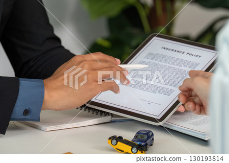 Insurance Consultation. Discussing car insurance policy details with a client. 130193814