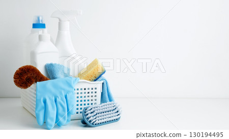 Household cleaning and hygiene concept. Cleaning supplies in a container, ready for a productive and satisfying spring refresh Household cleaning and hygiene concept. Cleaning supplies in a container, ready for a productive and satisfying spring refresh 130194495