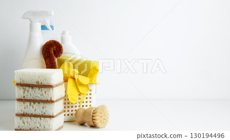 Household cleaning and hygiene concept. Cleaning supplies in a container, ready for a productive and satisfying spring refresh Household cleaning and hygiene concept. Cleaning supplies in a container, ready for a productive and satisfying spring refresh 130194496
