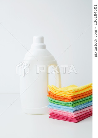 Laundry detergent branding mock up and clean stack of colorful towels. Household cleaning and hygiene concept packaging 130194501