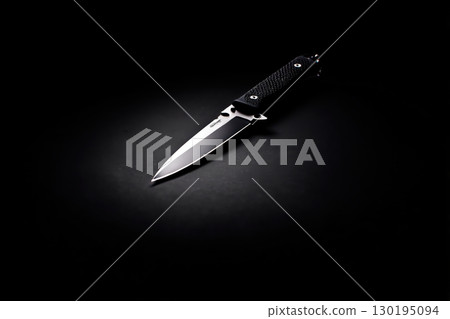 Tactical knife on a black background 130195094