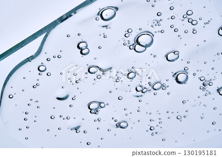 The texture of a clear shower gel or shampoo with bubbles. View from below. The texture of a clear shower gel or shampoo with bubbles. View from below. 130195181