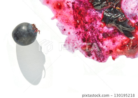 Isolated black grape with vibrant red and purple juice splash on white 130195218