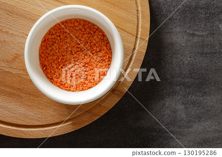 raw orange lentils in bowl, top view raw orange lentils in bowl, top view 130195286