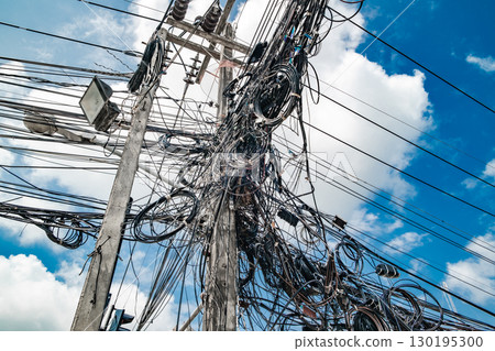 lots of coiled electrical wires wires on poles 130195300
