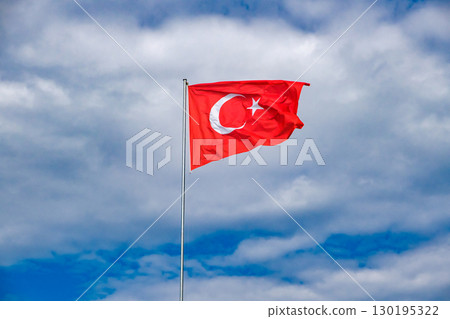 flag of Turkey on flagpole against sky with clouds flag of Turkey on flagpole against sky with clouds 130195322