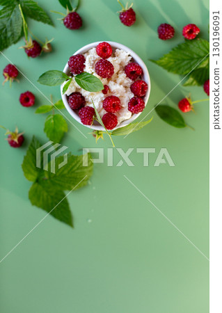 Natural cottage cheese with red raspberries and greens close-up Natural cottage cheese with red raspberries and greens close-up 130196091