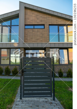 Modern townhouse with a secure gate and fence Modern townhouse with a secure gate and fence 130196233