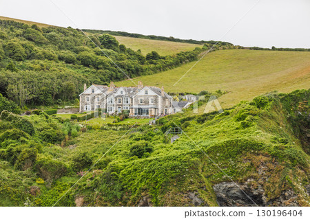 Elegant seaside estate nestled in verdant hills, rural landscape and dramatic cliffs Elegant seaside estate nestled in verdant hills, rural landscape and dramatic cliffs 130196404